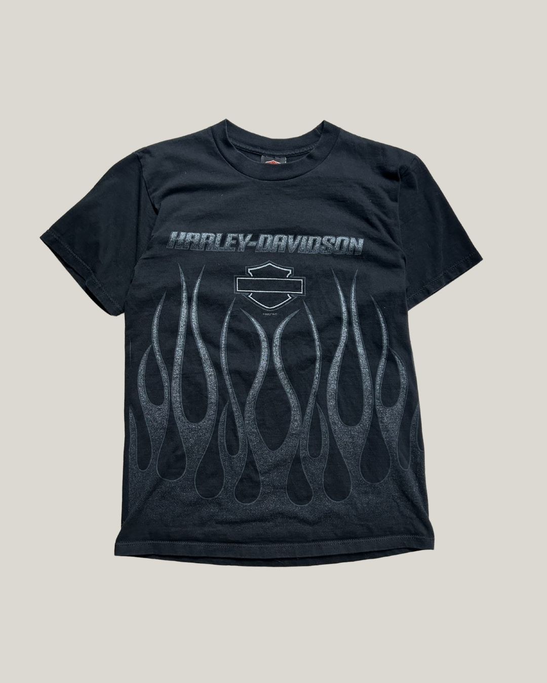 Black Harley-Davidson t-shirt with flame design and Harley-Davidson logo on a light gray background