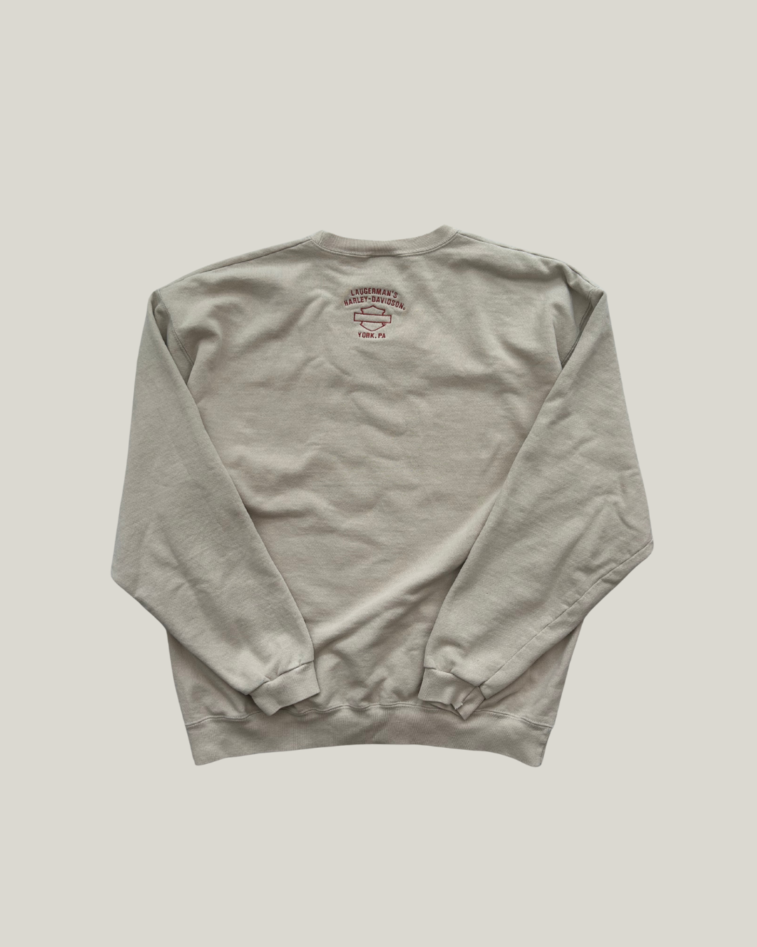 beige Harley-Davidson sweatshirt with a logo on the back against a light gray background