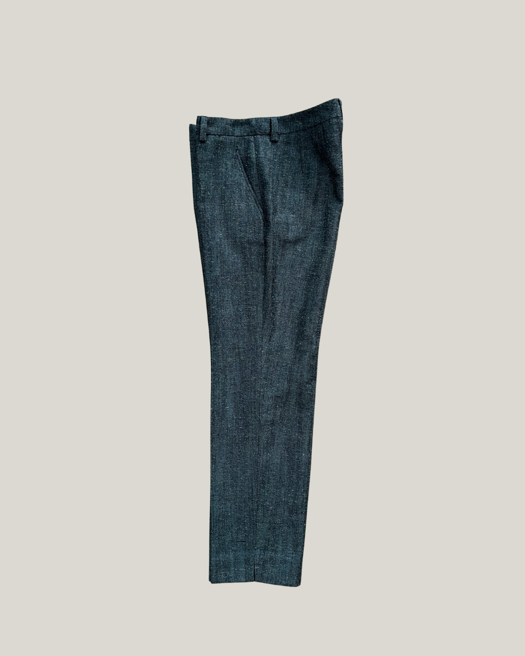Dark blue Versace pants on a light gray background