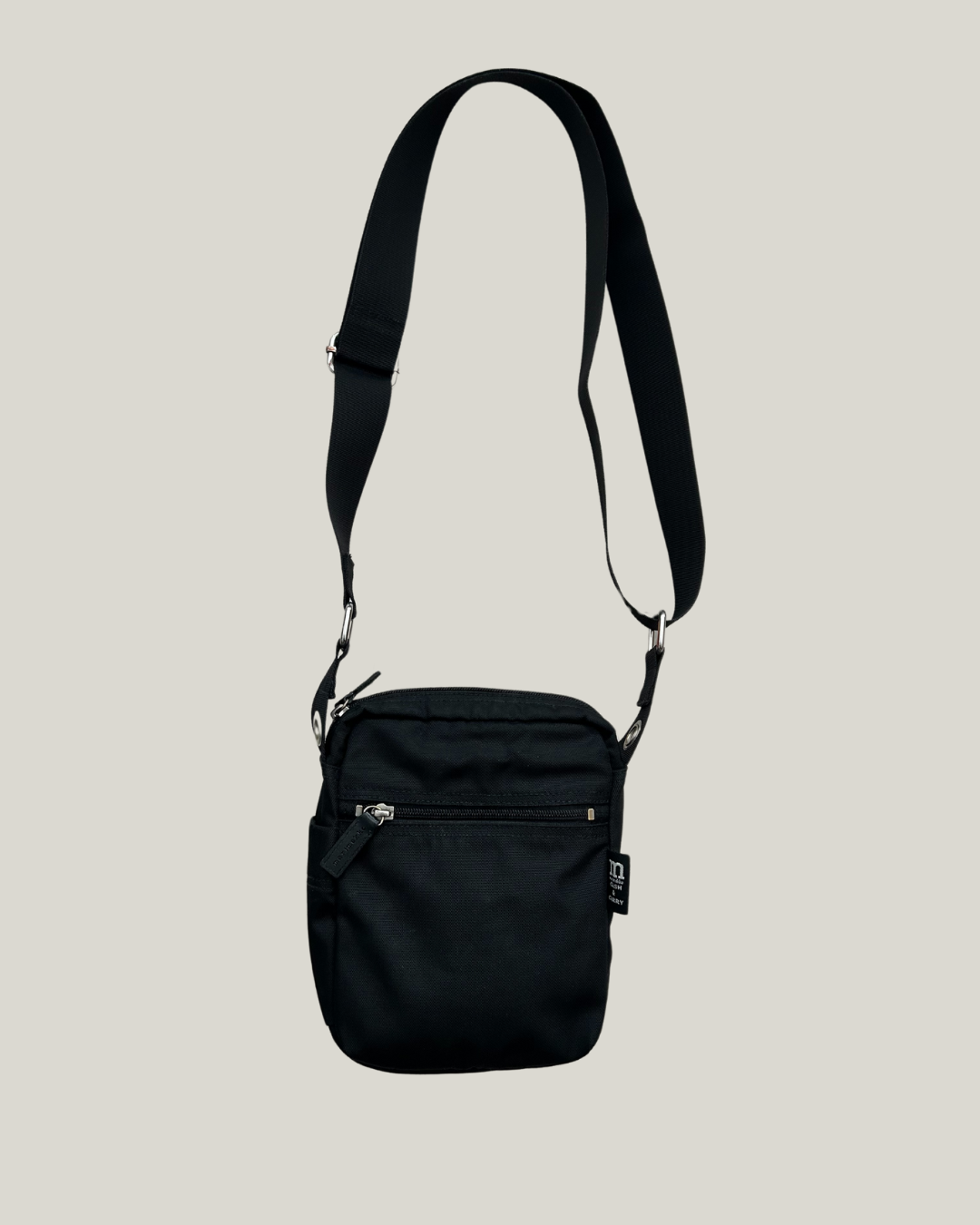 Black marimekko cash & carry crossbody bag on a beige background