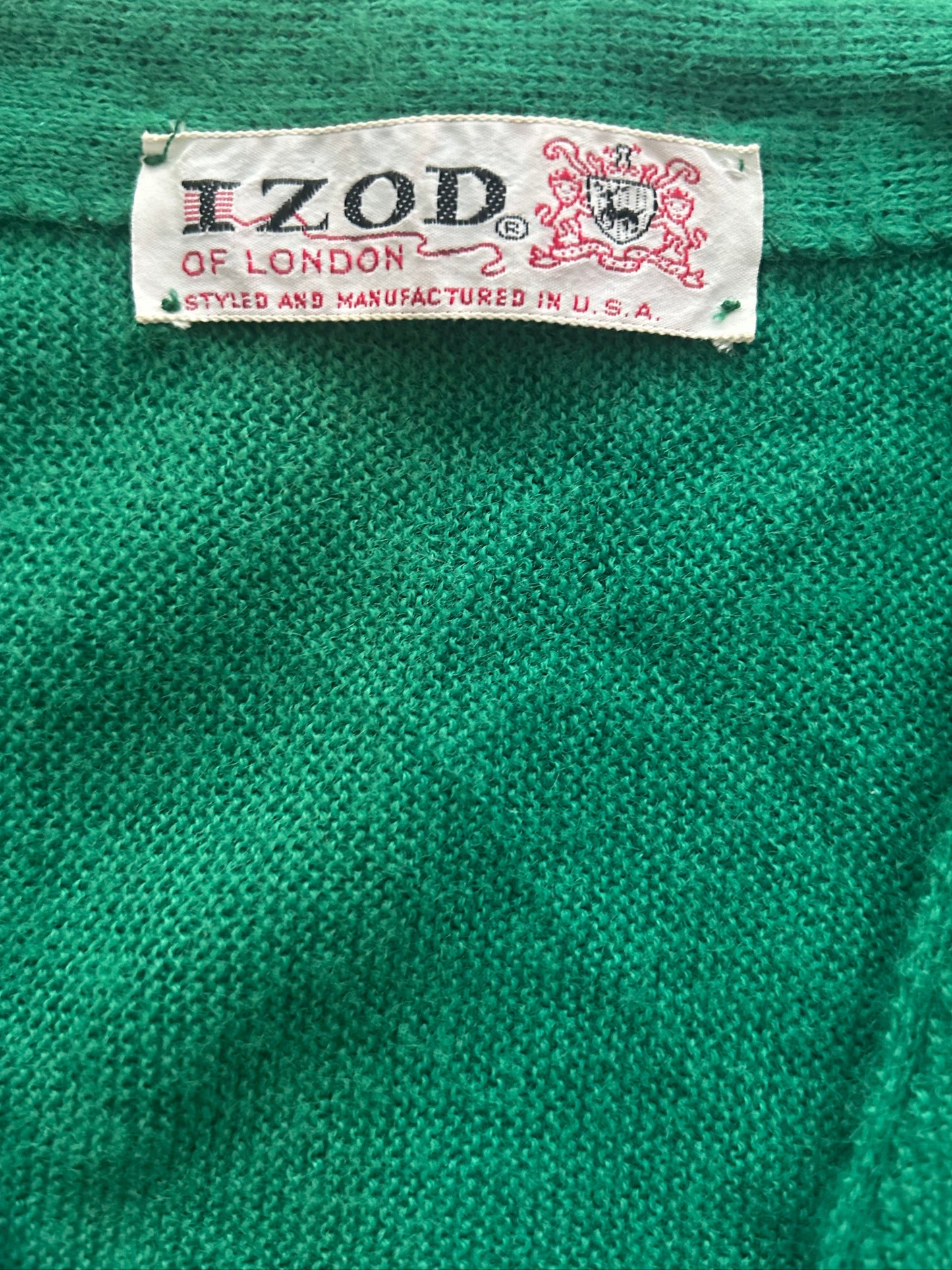 Close-up of a green fabric with an IZOD label on it.