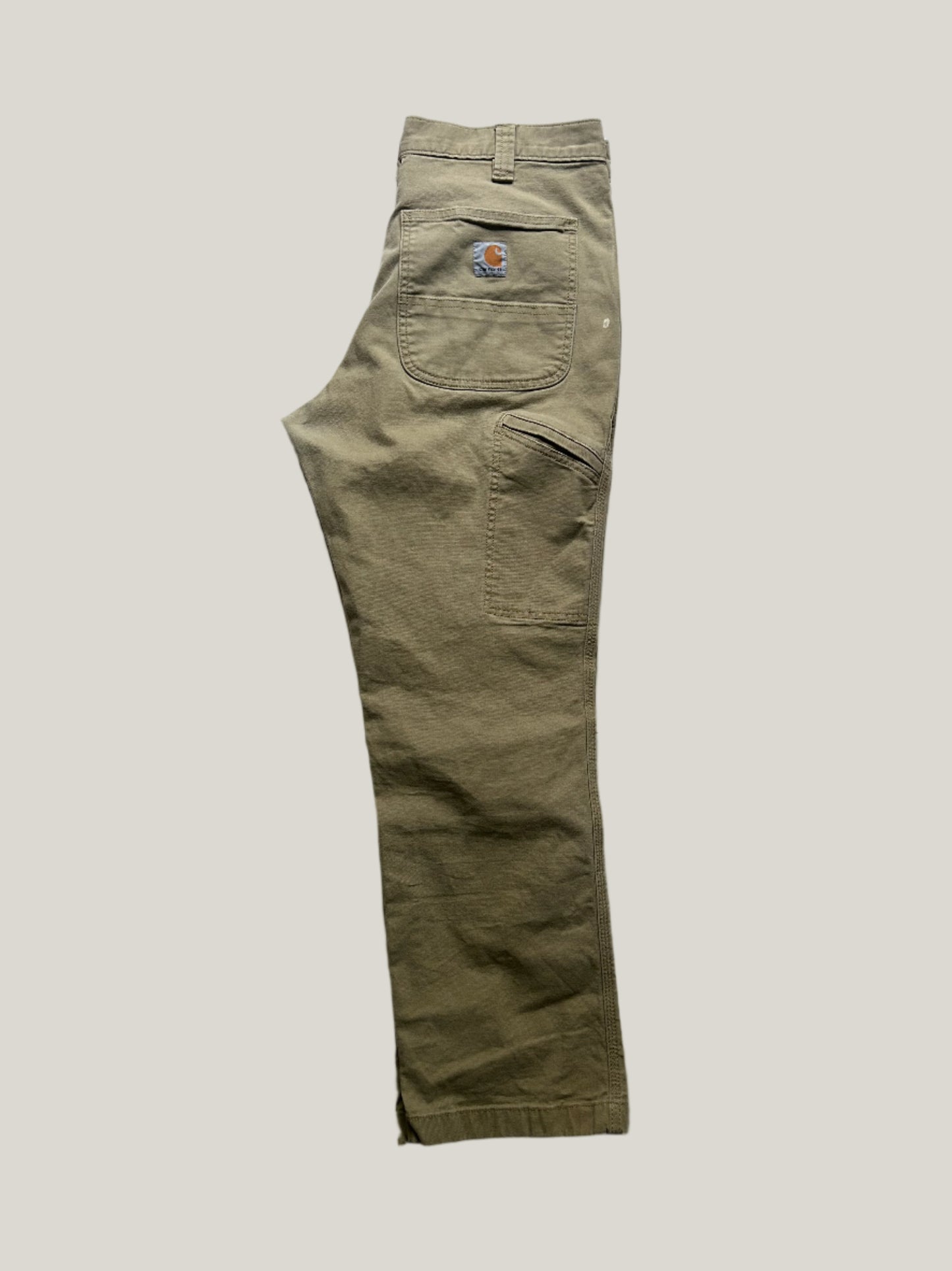 khaki carhartt pants with a carhartt logo on a back pocket