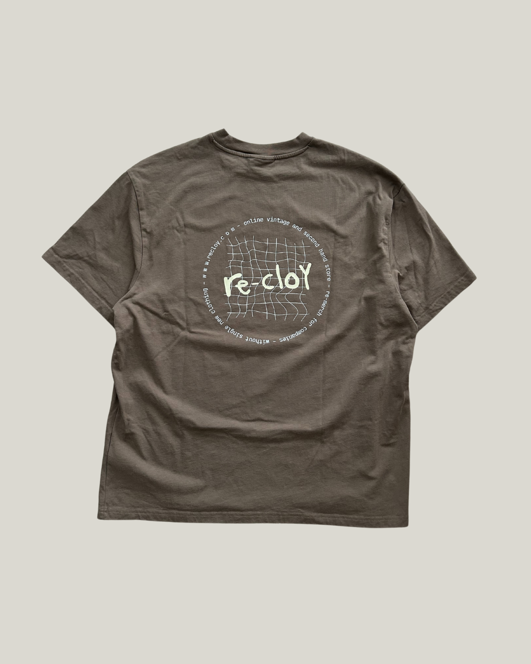 beige t-shirt with a circular graphic and text on a light gray background