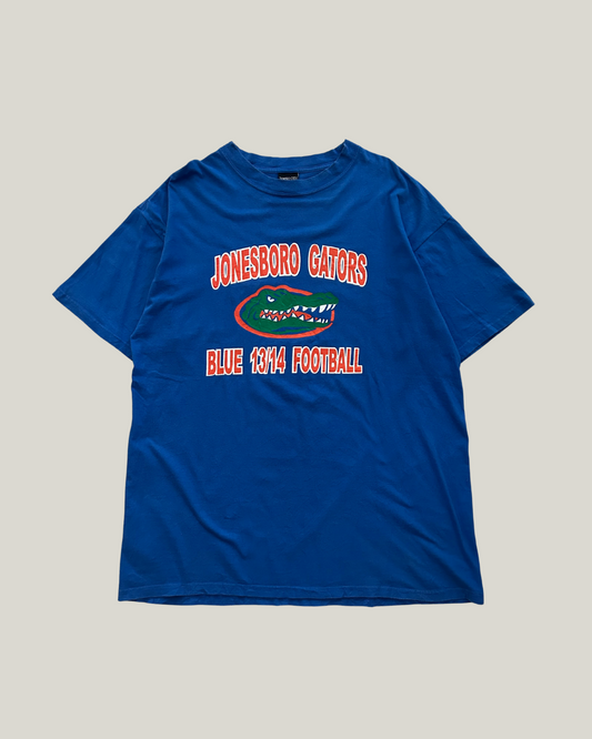 Blue t-shirt with 'Jonesboro Gators' text and gator logo on a gray background