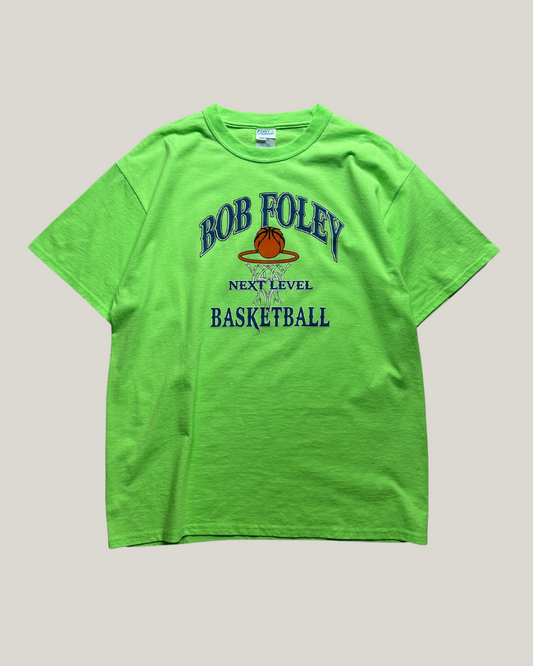 Green t-shirt with 'Bob Foley Next Level Basketball' text and logo on a gray background