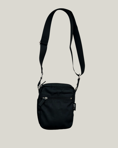 Black marimekko cash & carry crossbody bag on a beige background 