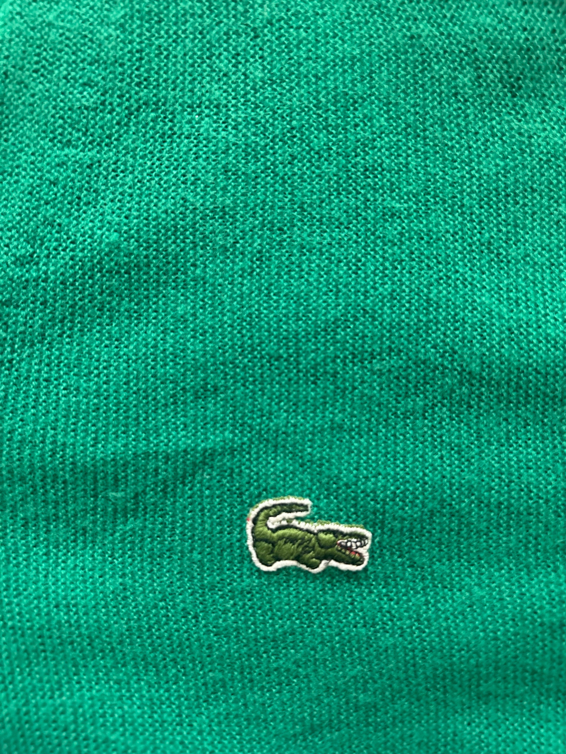 Close-up of a green textured fabric with a small logo on it.
