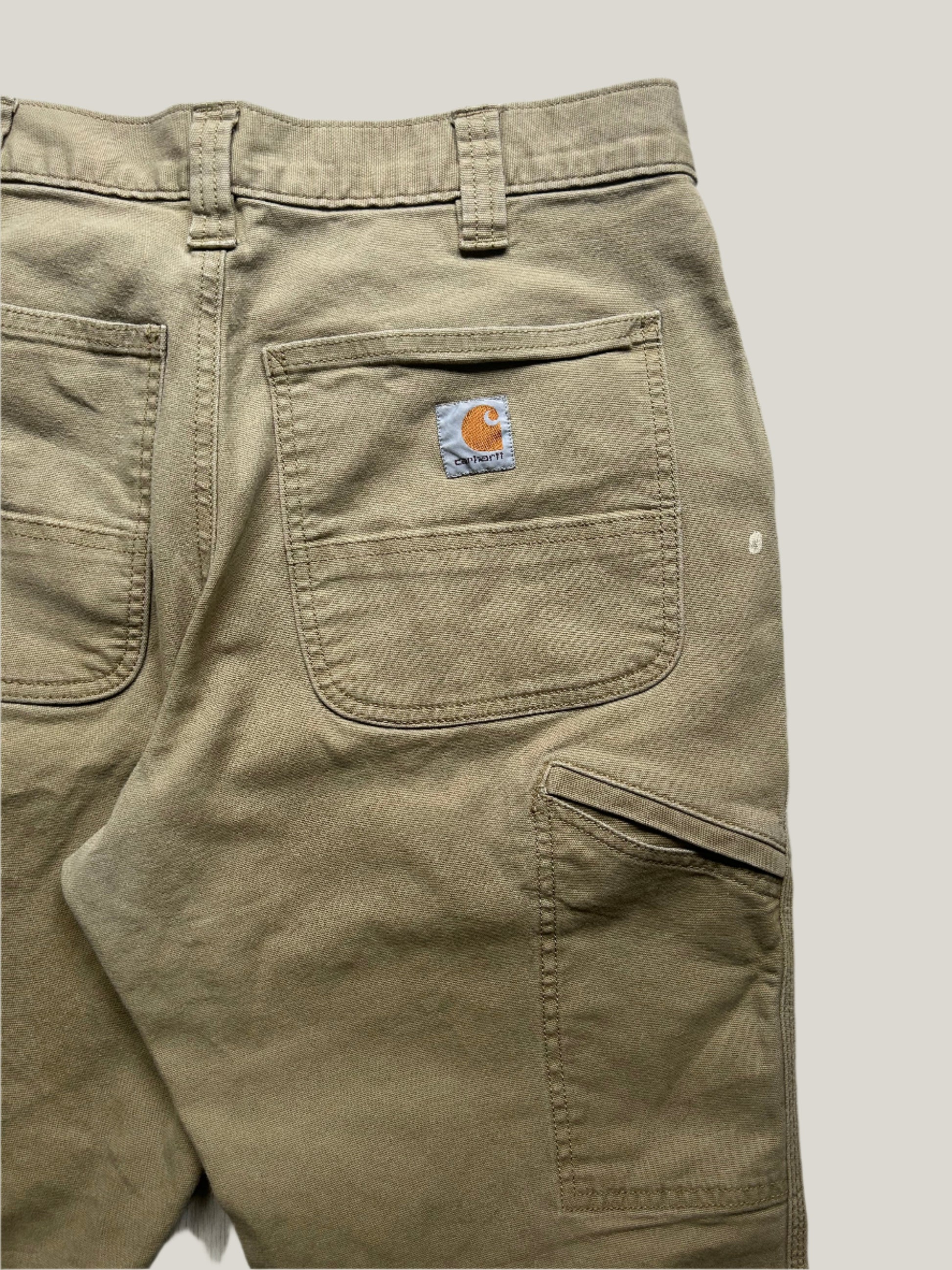 close up of Khaki pants with a Carhartt logo on a back pocket