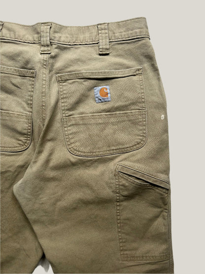 close up of Khaki pants with a Carhartt logo on a back pocket
