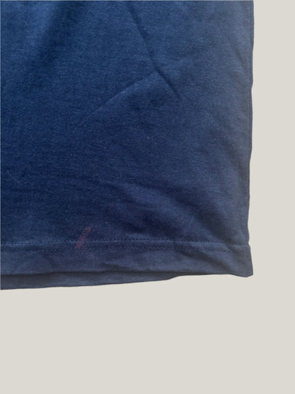 Light purple stain on a hem of a dark blue t-shirt
