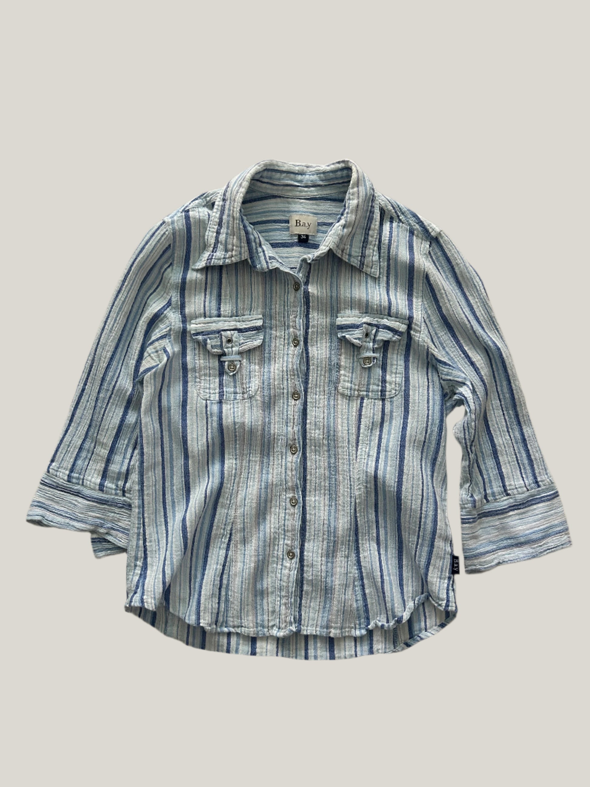 womens striped button-up shirt in different shades of blue with two chest pockets and 3/4 sleeves and collars